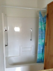 The tiny bathroom isn't even wide enough to accommodate the shower insert...it extends into the closet by about 15 inches.
