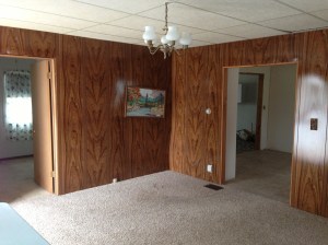 From the living room (and lovely painting that came with) looking toward the bedroom door on left and kitchen on right.