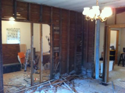 The closet is gone and the wall between the first floor bedroom and living room is following suit.